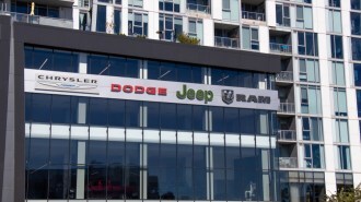 A dealership sign showing Stellantis brands
