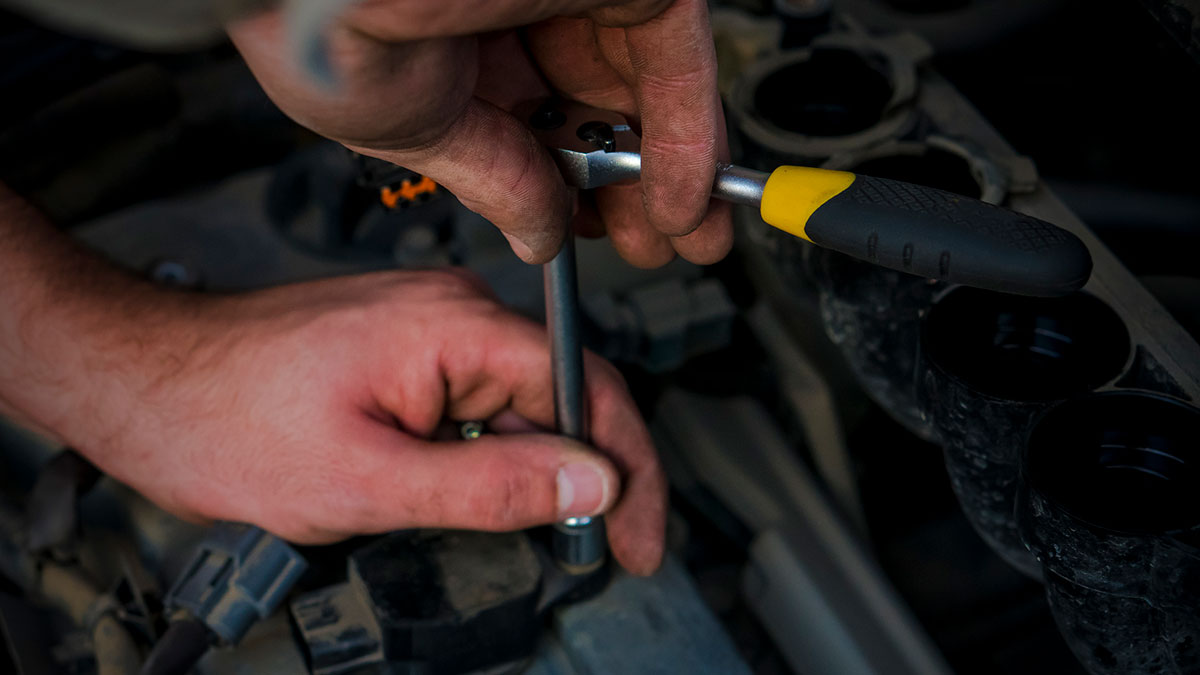Replacing Spark plugs in an engine.
