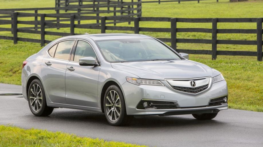 2016 Acura TLX V6 SH-AWD in silver with fences in the background.