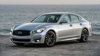 2016 Infiniti Q70 in silver on the beach at sunset.