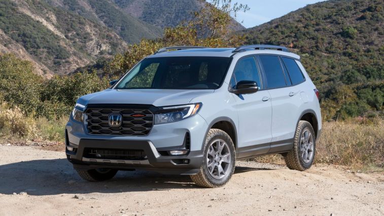 2024 Honda Passport TrailSport in grey with hills in the background.