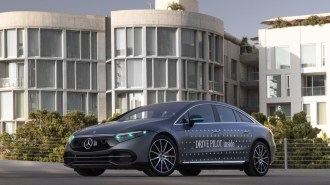 A Mercedes EQS Drive Pilot demonstrator with its turquoise lights illuminated