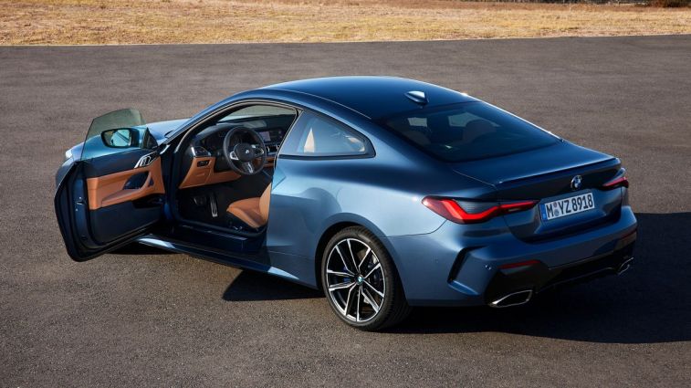2024 BMW 4 Series in blue rear view with driver side door open.