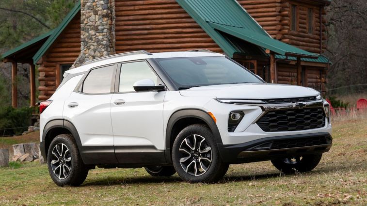 2024 Chevrolet Trailblazer ACTIV in white near a cabin.