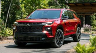 2024 Chevrolet Traverse RS in Radiant Red Tintcoat parked in a driveway.