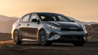 2024 Kia Forte GT Line in silver at sunset.