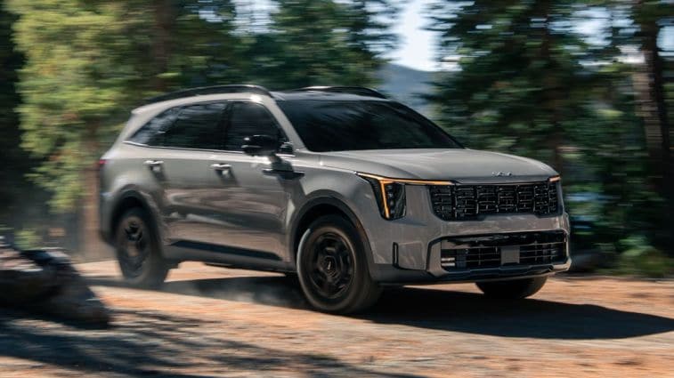 2024 Kia Sorento driving through a forest.