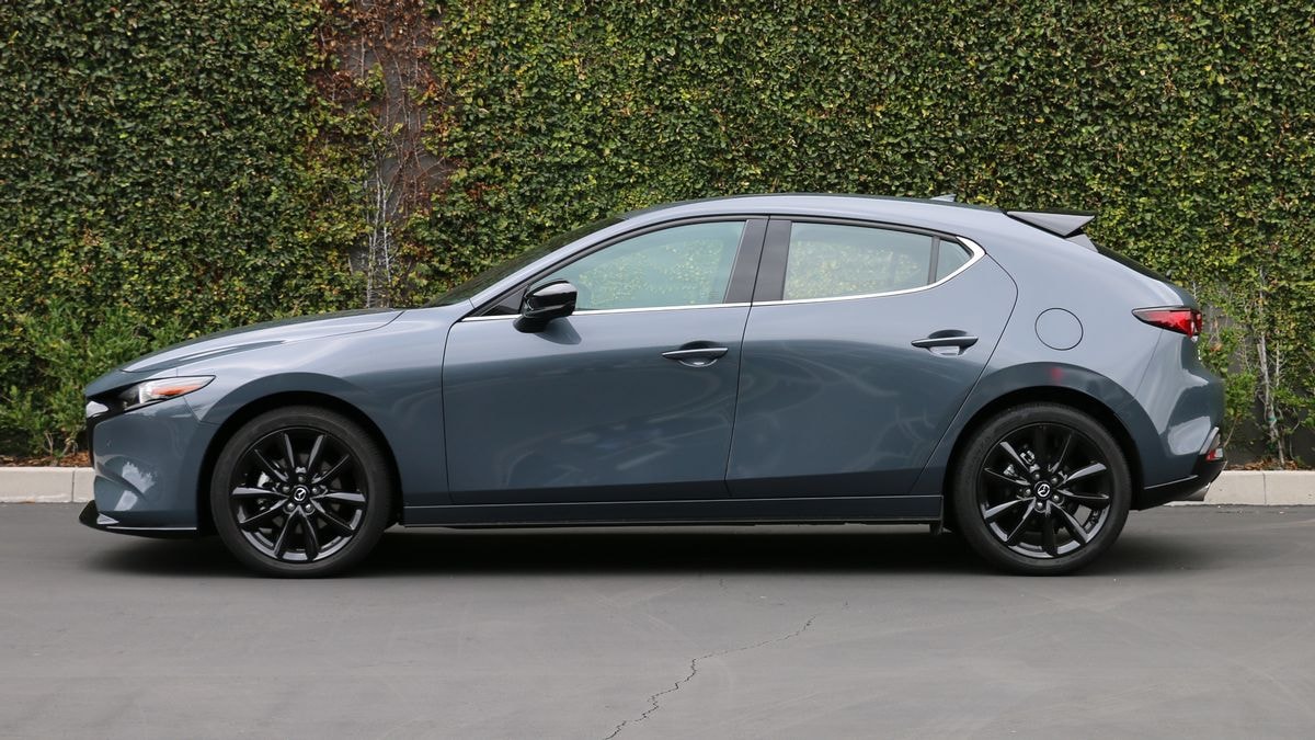 2024 Mazda3 2.5 Turbo Premium Plus in Polymetal Grey Metallic. near an ivy wall.
