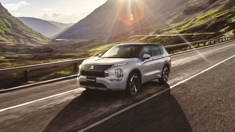 2024 Mitsubishi Outlander driving down a mountain road.