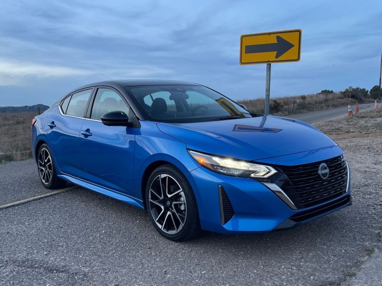 2024 Nissan Sentra SR in blue near a directional sign.