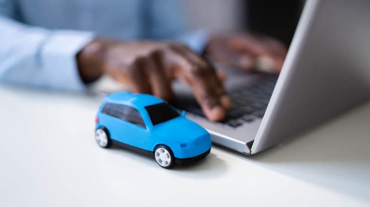 A person using computer to shop for car