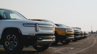 A line of Rivian vehicles parked side-by-side