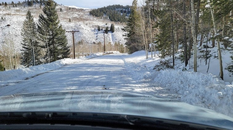 A snow-covered downhill road.