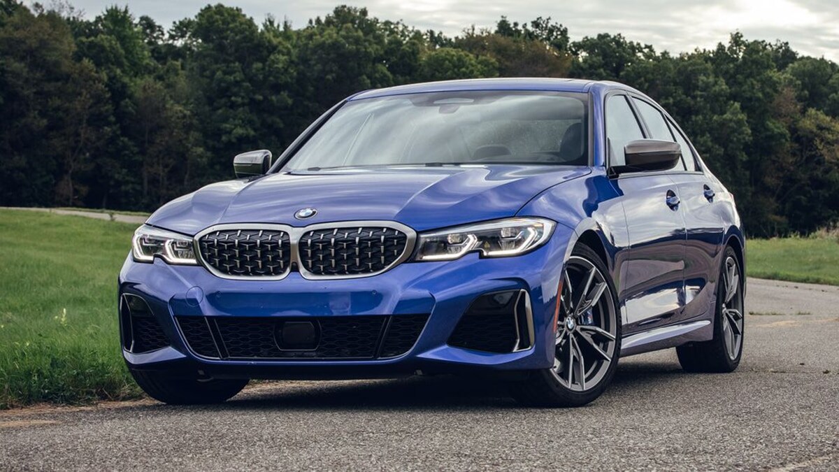 2020 BMW 3 Series in blue with trees in the background.