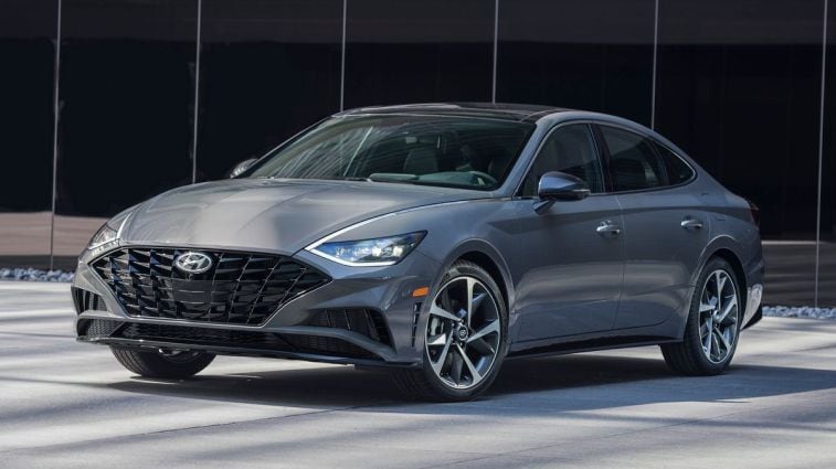 2023 Hyundai Sonata Hybrid in front of a glass building.