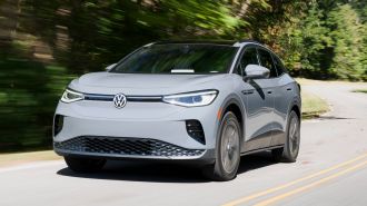 2023 Volkswagen ID.4 driving down a curvy road.