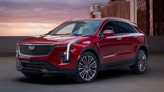 2024 Cadillac XT4 Premium Luxury in Radiant Red Metallic on top of a city parking structure.