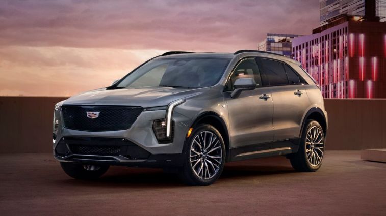 2024 Cadillac XT4 Sport in Argent Silver Metallic on top of a city parking structure.