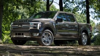2024 Ford F-150 Platinum in grey with trees in the background.