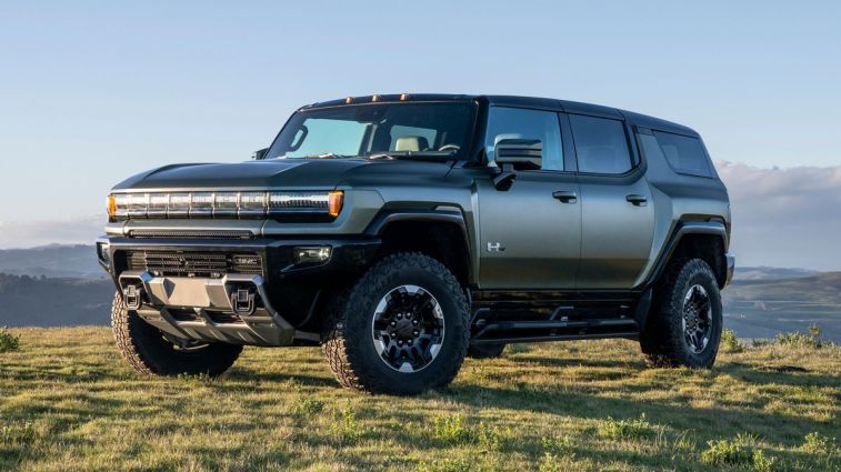 2024 GMC HUMMER EV SUV in Moonshot Green Matte overlooking mountain vista.