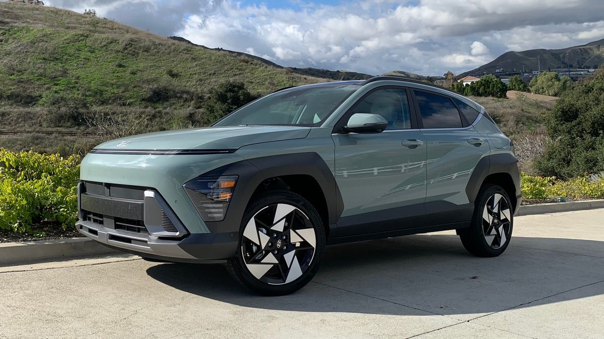 2024 Hyundai Kona Limited with hills and clouds in the background.