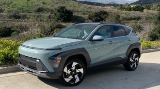 2024 Hyundai Kona Limited with hills and clouds in the background.