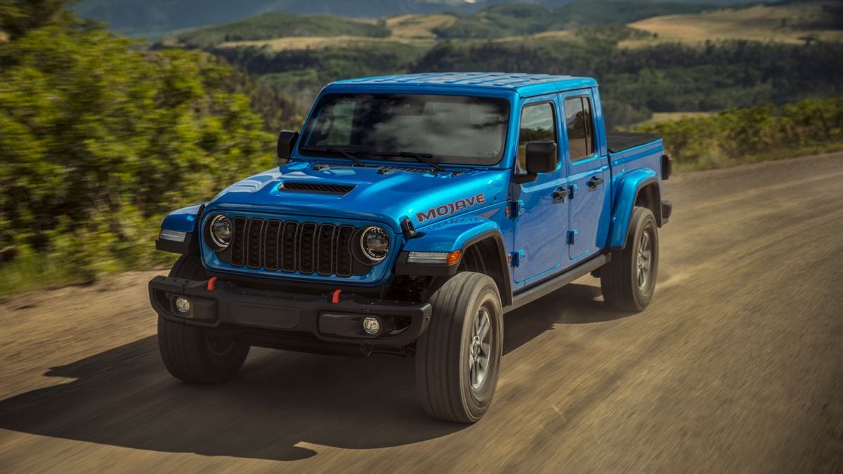 2024 Jeep Gladiator Mojave X driving down a dirt road.