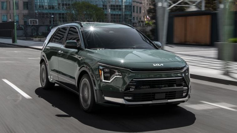 2024 Kia Niro driving down a street.