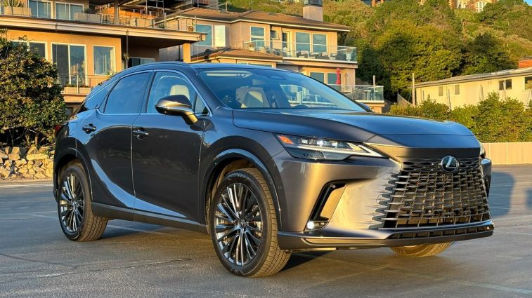 2024 Lexus RX 450h PHEV in a parking lot at sunset.