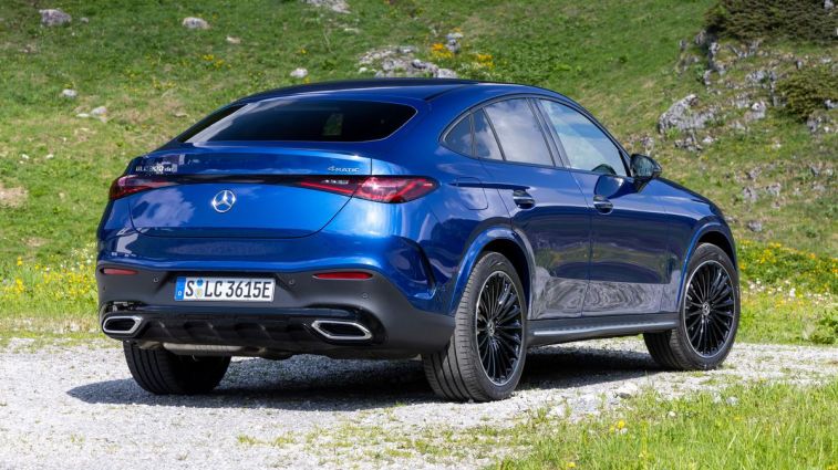 2024 Mercedes-Benz GLC 300 4MATIC Coupe in blue with green hill in the background.
