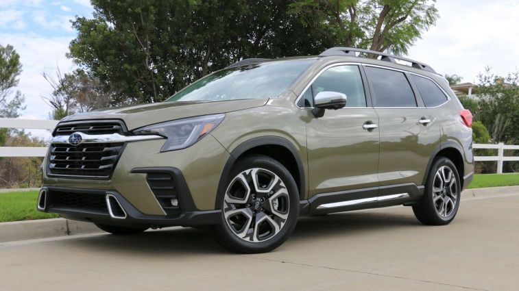 2024 Subaru Ascent parked next to a white fence.
