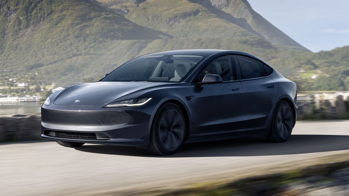 2024 Tesla Model 3 driving down a road.