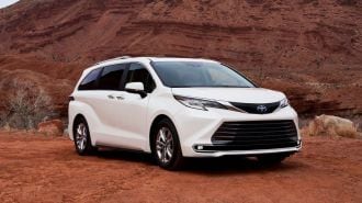 2024 Toyota Sienna Limited in white parked near red hills.