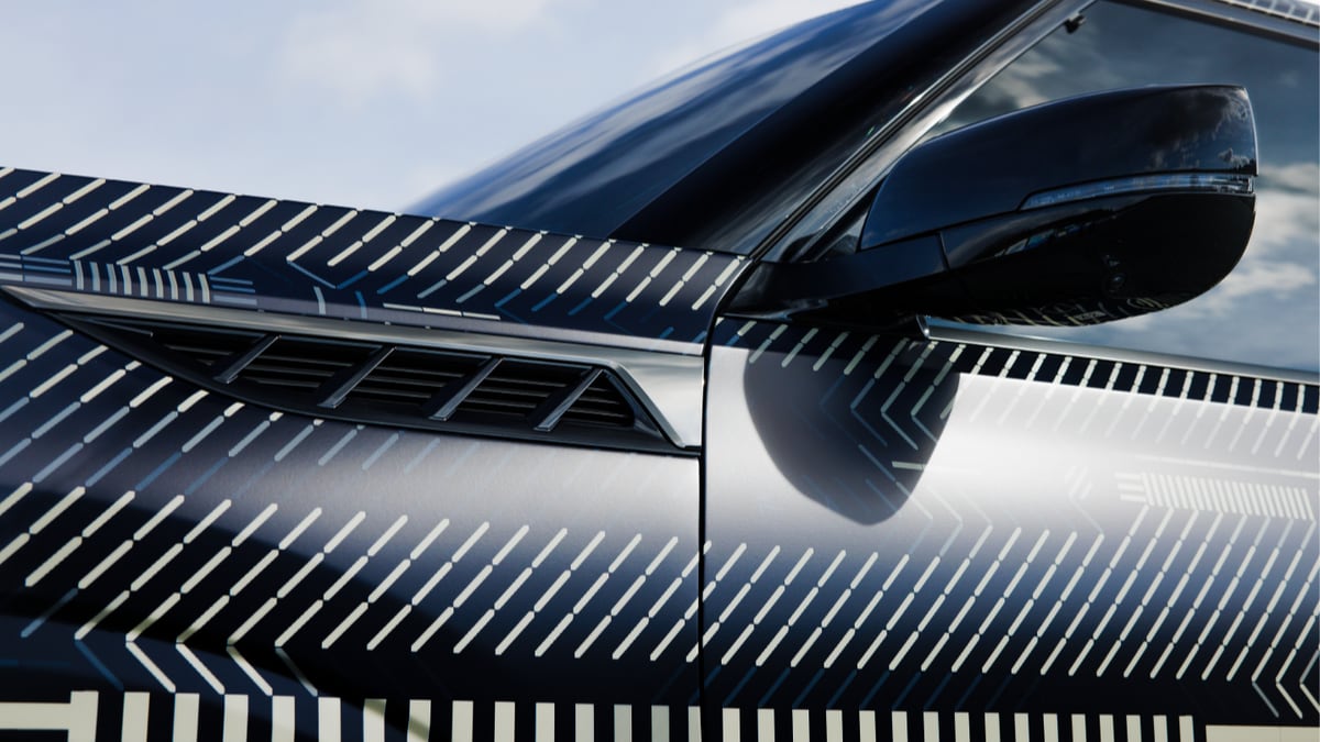 A teaser photo showing the side mirrors of the 2025 Infiniti QX80
