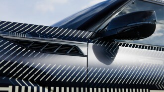 A teaser photo showing the side mirrors of the 2025 Infiniti QX80