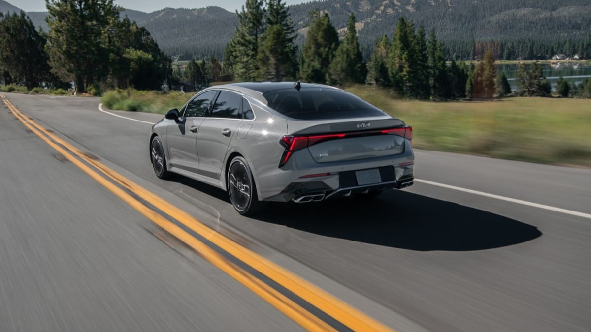 The 2025 Kia K5 seen from a rear quarter angle
