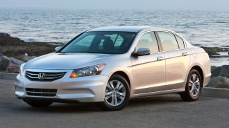 2012 Honda Accord SE Sedan in silver with the ocean in the background.