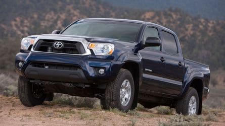 2013 Toyota Tacoma in blue with hills in the background.