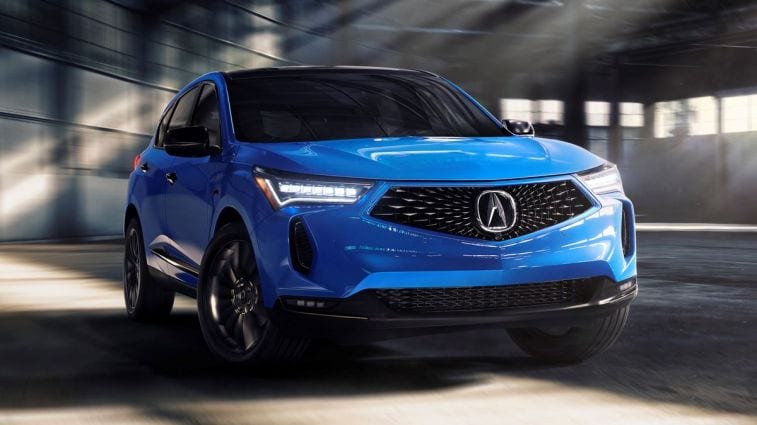 2024 Acura RDX in blue driving in the garage.