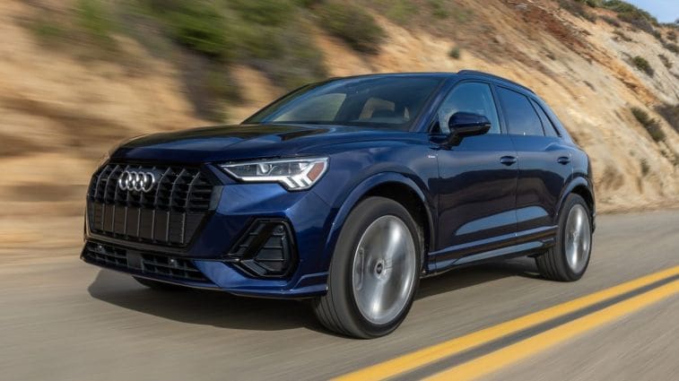 2024 Audi Q3 S Line in blue driving through some hills.