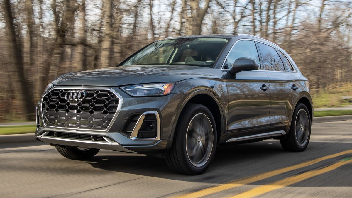 2024 Audi Q5 55 TFSI in grey driving down a road.