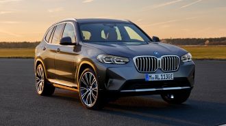 2024 BMW X3 parked on asphalt at sunset.