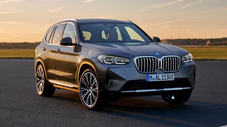 2024 BMW X3 parked on asphalt at sunset.