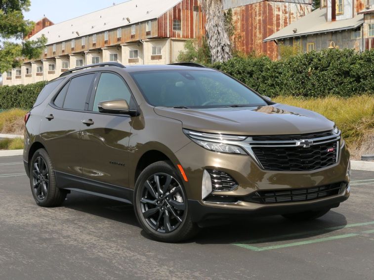 2024 Chevrolet Equinox RS parked near a metal building.