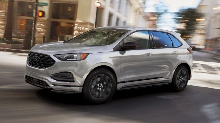 2024 Ford Edge SE with Black Appearance Package driving on a city street.