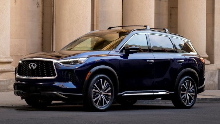 2024 Infiniti QX60 in blue parked in front of columns.