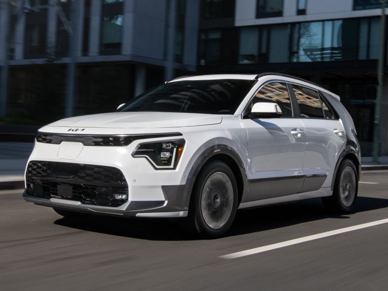 2024 Kia Niro EV driving down a city street.