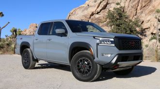 2024 Nissan Frontier Pro-4X in grey with rock formations in the background.