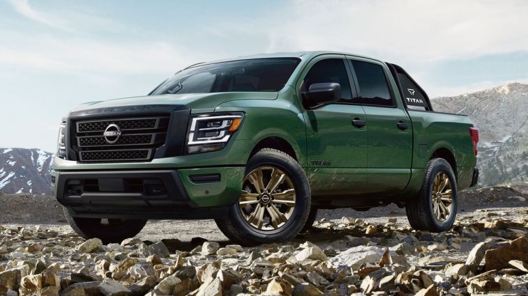 2024 Nissan Titan in green parked on rocks.