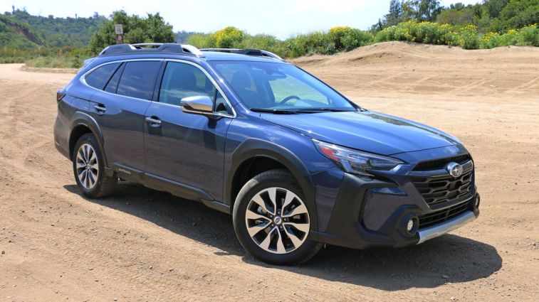 2024 Subaru Outback Touring parked on a dirt road.